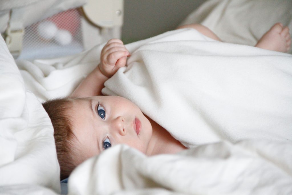 Cute baby in white blanket