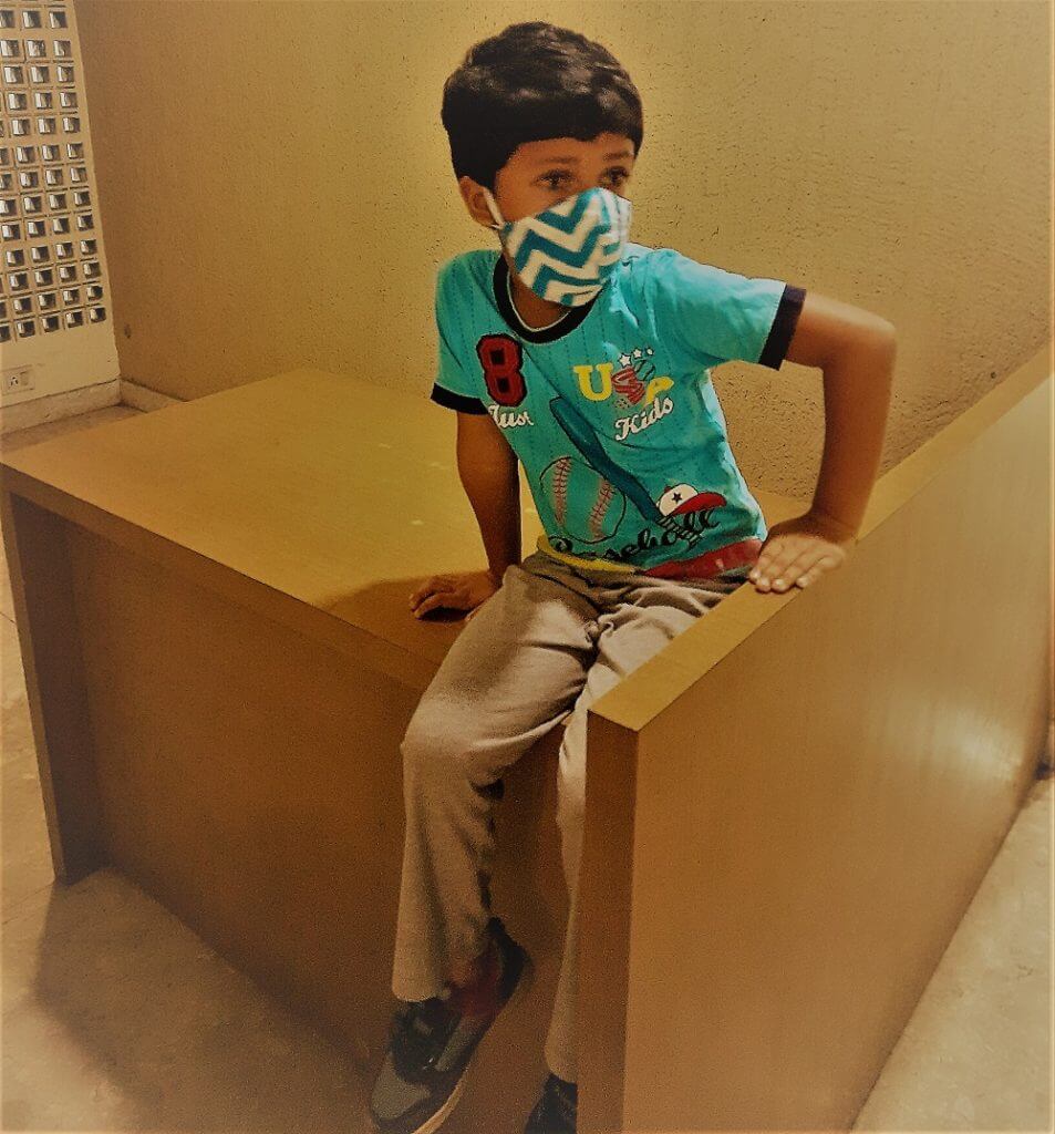 Child Sitting With Mask - new style of Parenting in India